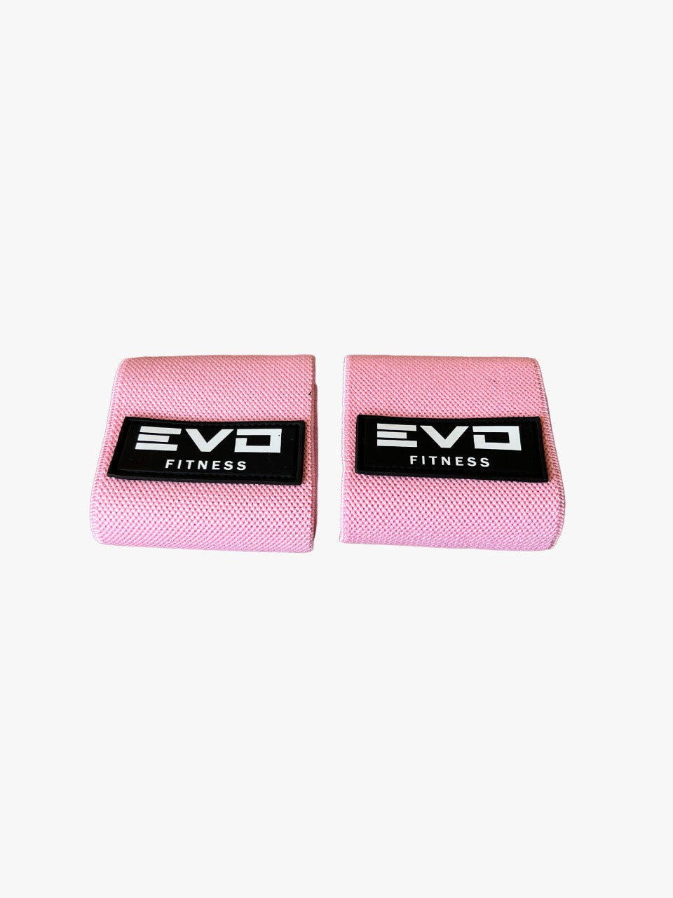 Pair of soft pink wrist wraps with black EVO Fitness logo patches.
