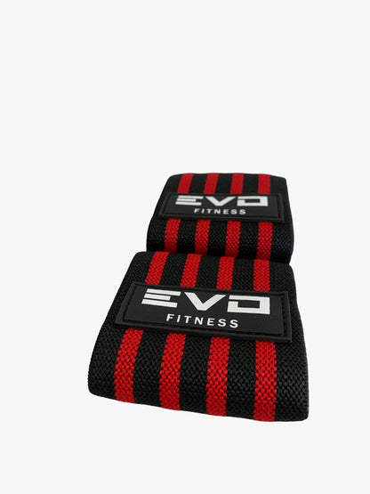 Black and red EVO Fitness wrist wraps with hook-and-loop closure and bold stripe design.